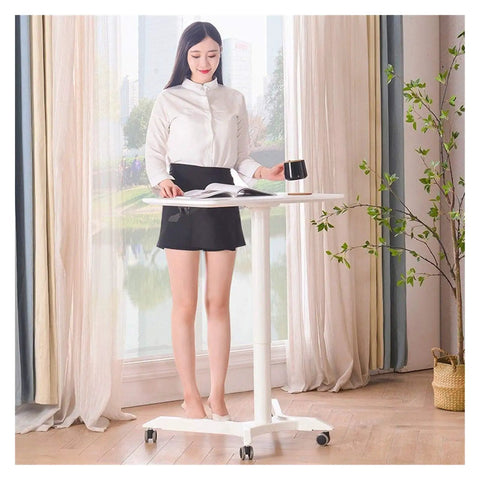 Woman using Built Different Overbed Table With Adjustable Height For Bedside Care and Work From Home Vibes, white MDF finish.