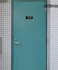 Durable ABS Door Sign With Full Adhesive Backing 2x6 Inch on a janitor closet door in a tiled wall, high visibility label