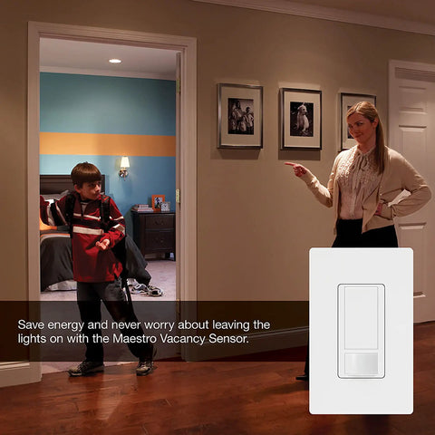 Woman pointing at LED Plus Dimmer With Vacancy Sensor For Single Pole And Multi Location Install Auto Off When Room Is Empty Go To LED Dimming Performance White Finish Great For LED Bulbs VP153M WH on wall.