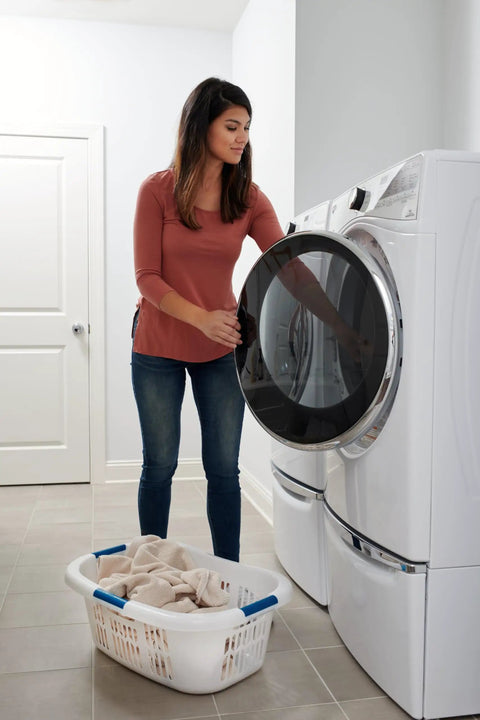Woman using Hip Hugger Laundry Basket With Easy One Hand Carry Grip One And A Half Bushel White Hamper Lightweight Stackable Organizer