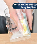 Person cleaning a Sourdough Starter Kit 2 Pack 34Oz Organic Glass Jars Wide Mouth With Lids, showing easy to clean feature.
