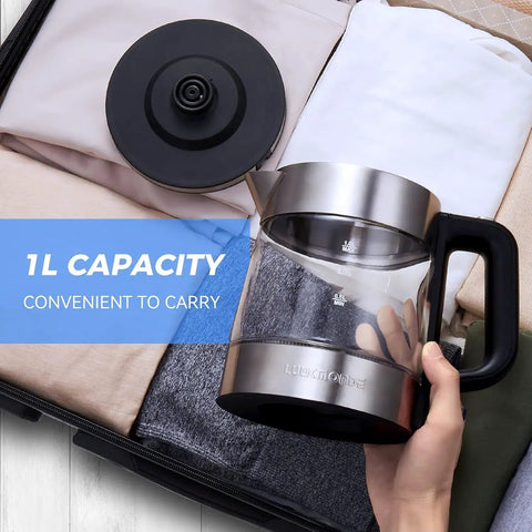 Electric Glass Kettle 1L, Fast 1500W Boil, Cordless Tea Kettle With LED Indicator, shown in a suitcase with its lid.