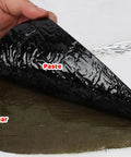 Badass Asphalt Roof Repair Tape With Heavy Duty Aluminum Foil Waterproof Sealant being peeled back to reveal adhesive side.