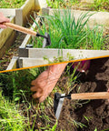 Japanese Weeding Sickle 13 Inch Hand Weeder And Garden Hoe for precision weed removal in narrow garden spaces, wood handle visible