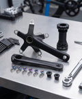 Lightweight 44T Crankset With 130 BCD, 170mm Arms, Includes Bottom Bracket For Easy Bike Conversion, Road Ready, Durable Cycle Part For Smooth Shifts And Quick Upgrades, black alloy crank arms and BB on workbench