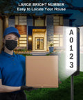 Solar Powered Address Sign For Yard With Vertical LED House Numbers IP65 Waterproof Outdoor Plaque next to delivery person.