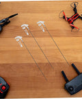 20 Pack Heavy Duty Metal RC Airplane Linkage Stoppers Plus Adjustable Push Rod Connectors For Fixed Wing Models Quick Swaps DIY Mods Rock Solid Flyin Gear on wooden surface with drones and remotes.