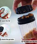 Close-up of Herb Grinder Containers Multipurpose All In One Durable Metal Spice Mill With Stash Jar For Grab And Go Airtight Sealable Containers Two Point Two Inch Sharpstone Grinder With Accessories And Carrying Pouch Storage Case Included, showing attachment and use with contents inside the jar.