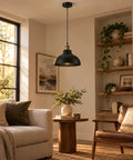 Black Industrial Metal Pendant Light, E26 Curvy Adjustable Ceiling Fixture hanging in a cozy living room, illuminating a table.