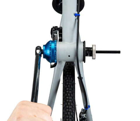 Bottom Bracket Retaining System With Double Sided Adapter Nut For Cartridge BBs in use on bike frame, black finish, spring loaded