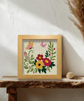 Two Pack Flower Butterfly Punch Needle Kit Set With Frames For Beginners on wooden shelf, featuring vibrant floral and butterfly design.