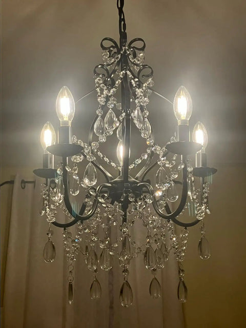 Black Crystal Chandelier With 5 Lights, K9 Crystal Raindrops, Iron Ceiling Light Fixture, shining in dark room.