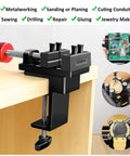 Tiny But Mighty Mini Drill Press Vise with rubber soft jaws, edge-mounted on a table, used for jewelry making and repairs.