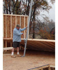Tranzporter wall jack, 16 ft, steel, side view with worker and wooden wall frame