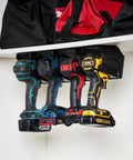Universal Drill Holder And Power Tool Organizer Wall Mount Rack for Cordless Drills organized under a shelf.