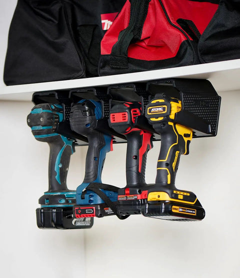Universal Drill Holder And Power Tool Organizer Wall Mount Rack for Cordless Drills organized under a shelf.