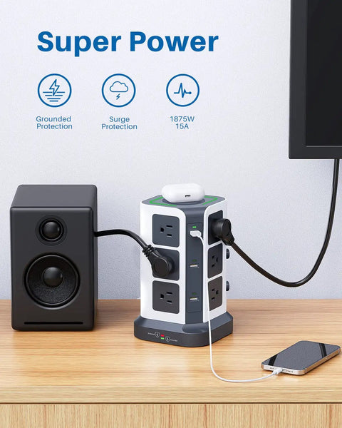Power Strip Tower With 15W Wireless Qi Charger And Surge Protector, 12 AC Outlets, 6 USB Ports, on desk with speaker and phone.
