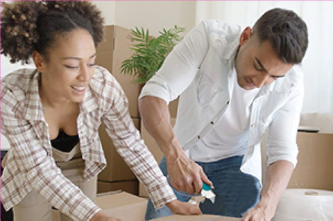 Two people opening a box with utility knife, using Ten Pack Utility Knife Blades Refills For Box Cutters.