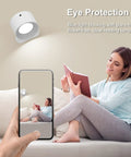 Woman reading under a 2 Pack Remote Led Wall Sconce Light With Rechargeable Battery No Outlet Needed, 3 Colors And 3 Brightness Levels, 360 Degree Magnetic Rotating Head, Easy Install Bedside Reading Lamp Black