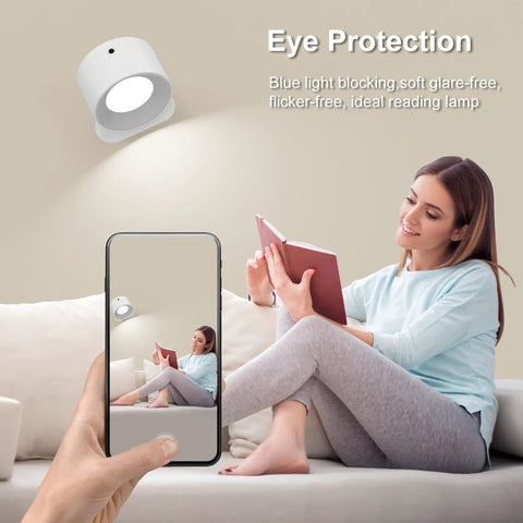 Woman reading under a 2 Pack Remote Led Wall Sconce Light With Rechargeable Battery No Outlet Needed, 3 Colors And 3 Brightness Levels, 360 Degree Magnetic Rotating Head, Easy Install Bedside Reading Lamp Black