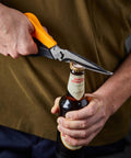 All In One Garden Tool 7-In-1 Pruning Shears For Plant Care With Titanium Knife opening a bottle with the built-in opener