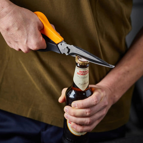 All In One Garden Tool 7-In-1 Pruning Shears For Plant Care With Titanium Knife opening a bottle with the built-in opener