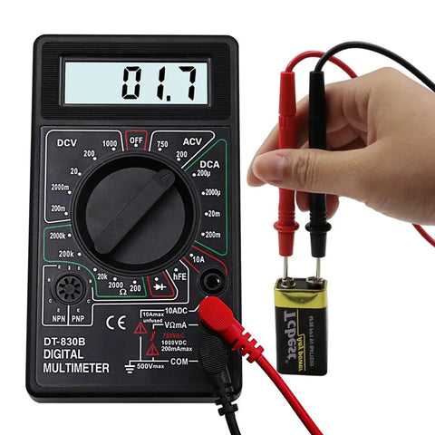 Hand using Digital Multimeter DT-830D With AC DC Measurement, Diode And Transistor Test, Continuity Buzzer, displaying 1.7