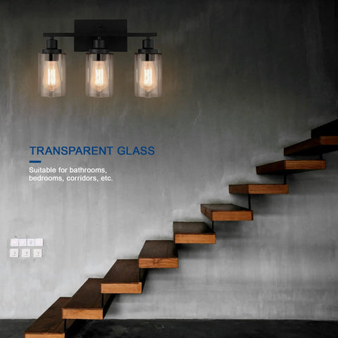 Matte Black 3 Light Vanity Wall Sconces With Clear Glass Shades installed near modern wooden staircase
