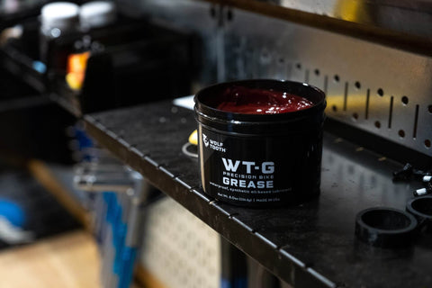 Precision Bike Grease for All Weather Performance, Ultra Low Viscosity Lube in black container on workshop shelf, 2 Oz.