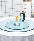 24 Inch Heavy Duty Lazy Susan 360-Degree Turntable with Tempered Glass on dining table with bottle and glasses.