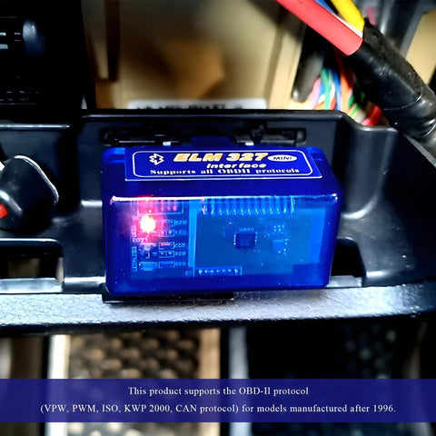 ELM327 OBDII Car Diagnostic Scanner With Bluetooth Pro Auto Code Reader installed in a vehicle's OBD2 port, red LED lit