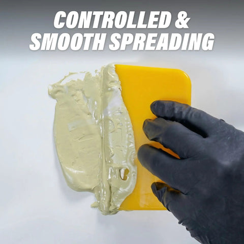 Bulk 100 Pack Yellow 4 Inch Auto Body Filler Spreaders for Putties Glazes Caulks and Paint Easy Application Reusable Plastic Spreader for Automotive Repairs and DIY Projects. gloved hand spreading filler