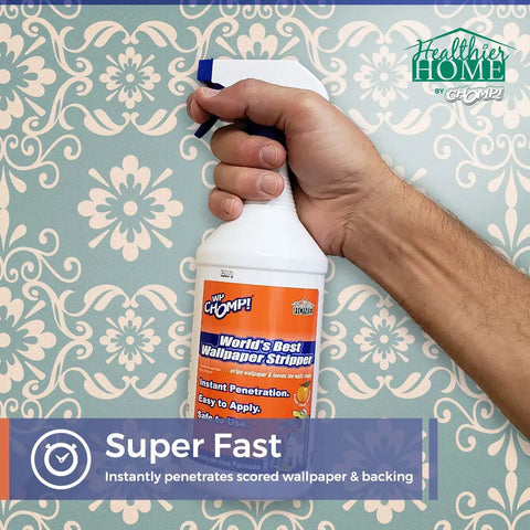 Person holding World's Best Wallpaper Stripper And Sticky Paste Remover, Citrus Scent, 32oz against floral wallpaper background.