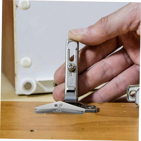 Installing 12-Piece Galvanized Iron Toggle Bolts With Wings For Drywall And Hollow Walls with hand demonstrating secure mounting