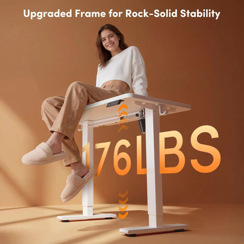 Woman sitting on 32 Inch Electric Standing Desk With Adjustable Height From Sitting To Standing, showcasing desk stability at 176 lbs