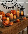 Amber LED Flameless Pillar Candles With Remote Timer 5 Pack and jack-o'-lanterns on wooden table for Halloween decor