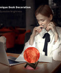 Woman working at desk with Moon Galaxy Lamp Night Light For Kids With 16 Colors 3D LED Moon With Stand Remote And Touch Control