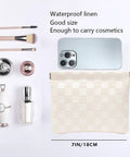 Leather Cosmetic Pouch For Purse With Secure Snap Closure And Slim Profile next to cosmetics and phone, 7x5.5 inch waterproof design.