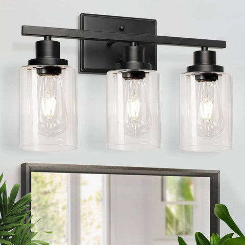 Three Light Black Vanity Light Fixtures With Clear Glass Shades above mirror, E26 Base, modern wall sconces for bathroom.