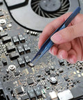 Hand using Ultra Fine 0.15mm Ti Alloy Tip For Phone Board Repair Soldering on a circuit board for precise electronics work.