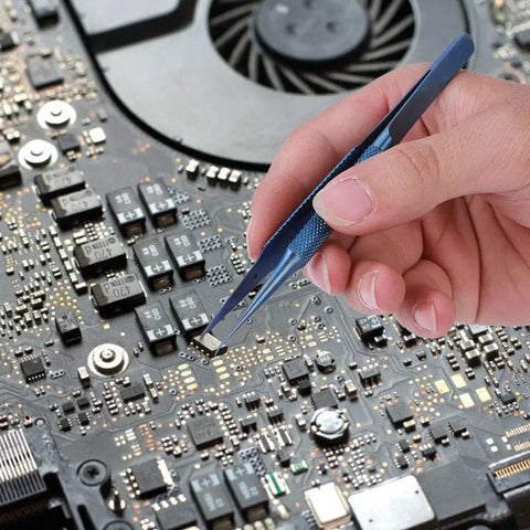 Hand using Ultra Fine 0.15mm Ti Alloy Tip For Phone Board Repair Soldering on a circuit board for precise electronics work.