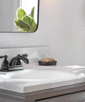 Elmhurst Two-Handle Bath Faucet Centerset In Oil Rubbed Bronze, 4-Inch Fits 3-Hole Installations on a white bathroom sink