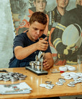 Person using Bulk 400 Piece Button Making Kit No Brainer With Fifty Eight Millimeter Button Parts, Pin Backs, Metal Shells.