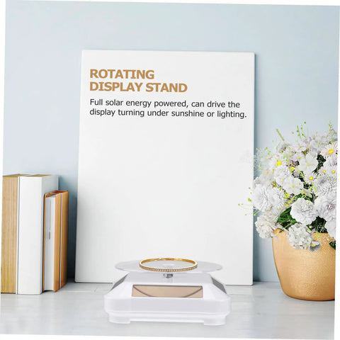 Solar Powered Rotating Display Turntable For Jewelry Phones And Accessories lightweight unit showcasing a gold bracelet on a stylish stand.