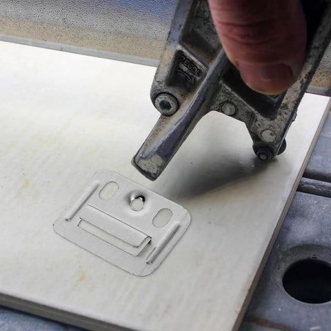 Solid Stainless Steel Wall Panel Connectors For Cabinets And Drywall being installed with a tool on a wood panel.