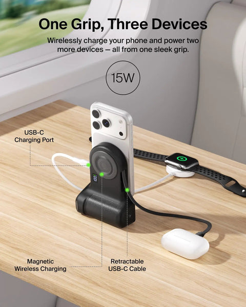 Magnetic Wireless Camera Grip Power Bank 9300mAh with Retractable USB C Cable, charging three devices on a desk.