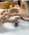 Hands repairing clock with Coil Spring For Mechanical Clock Repair And Vintage Alarm Clock Quill Spring Assembly part shown
