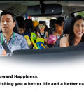 Family of four in a car with a cheerful expression, father in blue shirt, mother and children in the back with recreational items