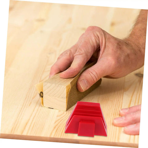 Hand holding sandpaper on a wood plank with red 12 Piece Modular Wrench Organizer Tray For Workbenches Garages And DIY Projects Durable Plastic Tool Holder nearby.