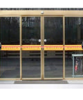 Rock Solid Infrared Through Beam Sensor With Alarm Transmitter for garage doors and sliding gates installed on glass entrance.